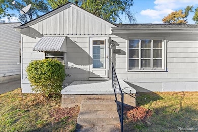 View of side of property with board and batten siding and roof with shingles