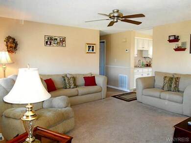 Living Room Wall to wall carpeting and ceiling fan