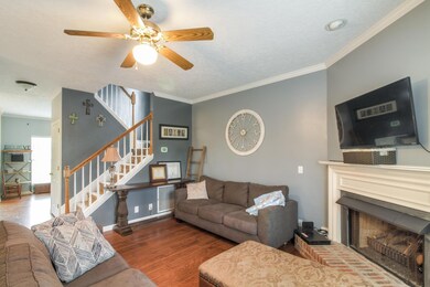 Open Family Room with Gas Fireplace.  Notice the beautiful hardwood floors that run throughout the home. 