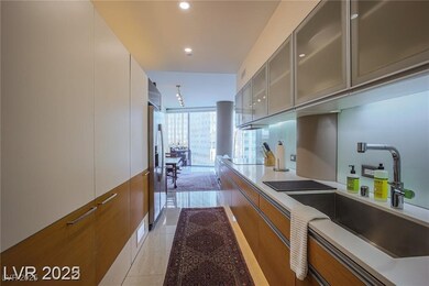 Kitchen with modern cabinets, brown cabinets, recessed lighting, stainless steel fridge with ice dispenser, and light tile patterned floors