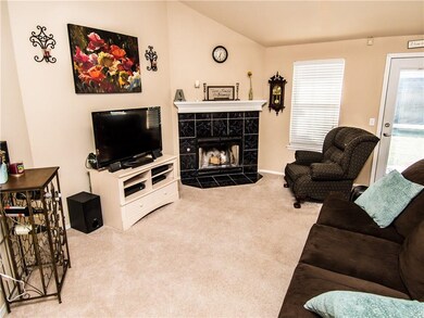 Living room with fireplace & vaulted ceiling.