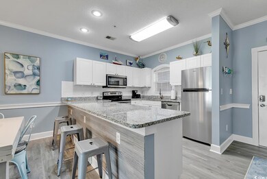 Kitchen with crown molding, light hardwood / wood-