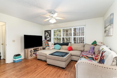 Living room featuring a textured ceiling, ceiling 