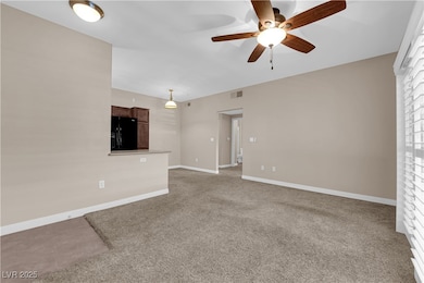 Unfurnished living room with a ceiling fan and car