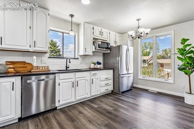 Kitchen featuring decorative light fixtures, sink,