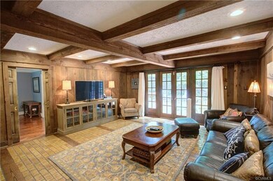 Family room with tile and wood floors.  Exposed be