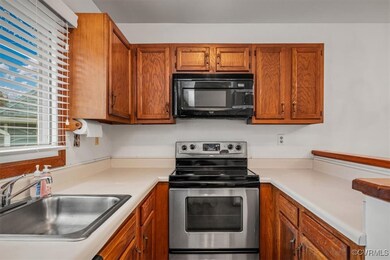 Kitchen with stainless steel electric stove and si