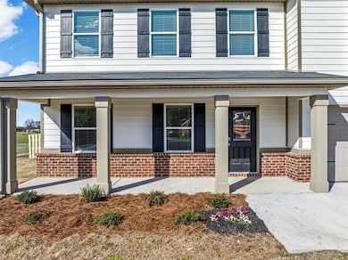 View of front of property with covered porch, conc