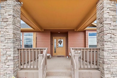 Doorway to property with a shingled roof
