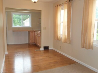 Dining area with new laminate flooring is open to 