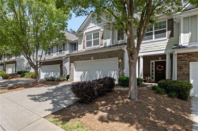 View of property with a garage and driveway