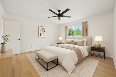 Bedroom featuring light wood finished floors, cei