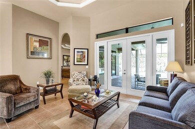 Living room with family room through the arched op
