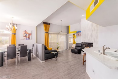 Living area featuring a chandelier and wood finished floors