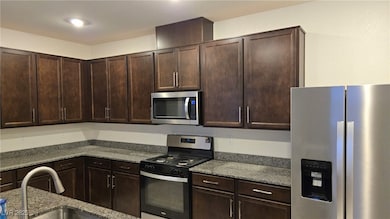Kitchen with appliances with stainless steel finis