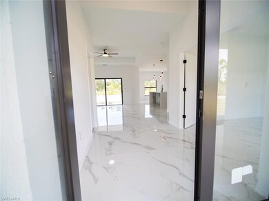 Corridor featuring light marble finish floors and baseboards