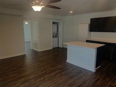 Kitchen featuring ceiling fan, a kitchen island, a