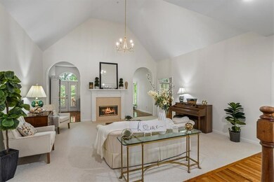 Heart of this home Great room boasting vaulted ceilings for this gathering spot with new chandelier