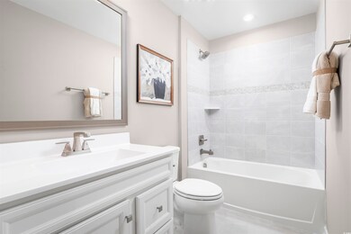 Full bathroom featuring tiled shower / bath, vanit
