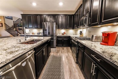 Kitchen features stainless steel sink and applianc