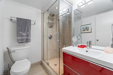 Bathroom featuring a shower stall, toilet, and van