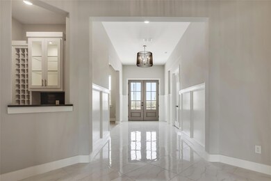 Tiled entrance foyer with french doors
