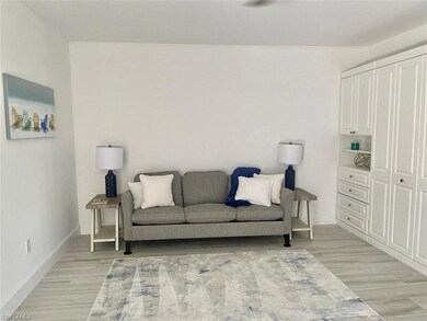 Living area with baseboards and light wood-style floors