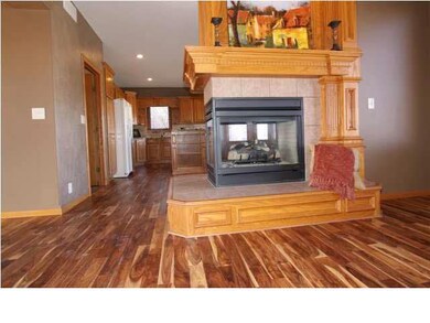 TWO-WAY FIREPLACE OPENS TO HEARTH/KITCHEN