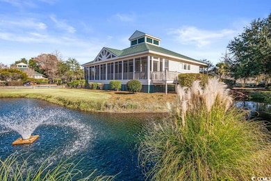 Rear view of house featuring a sunroom and a water