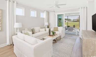 Living room featuring light wood finished floors, a ceiling fan, and ornamental molding