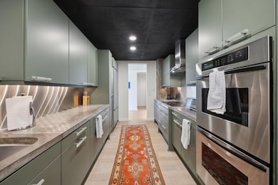Kitchen with stainless steel double oven, light co