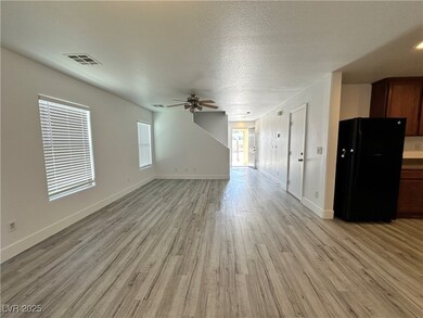 Unfurnished living room featuring visible vents, b