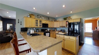 Wow! Family Friendly Kitchen. Open concept. Customized cabinets. Slate Floors, Island w/electrical outlets.  Eat in Dining Kitchen w/overhanging countertops.  Walk-in Pantry. Large Supply Closet under stairs. New fridge 2017, New dishwasher 2017, Gas