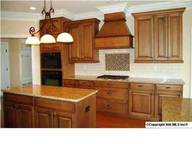 Beautiful cabinetry with granite countertops, backsplash, stainless steel appliances......similar picture