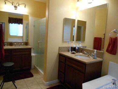 Master bathroom with dual sinks and rain glass sho