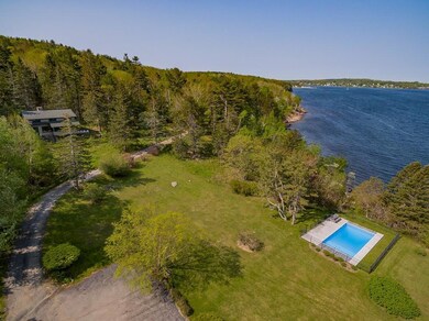Looking down at the pool, yard and...