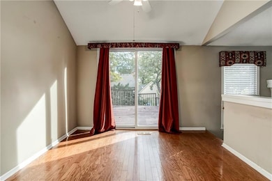 Dining area with large sliding doors offering direct access to the raised deck and backyard views.