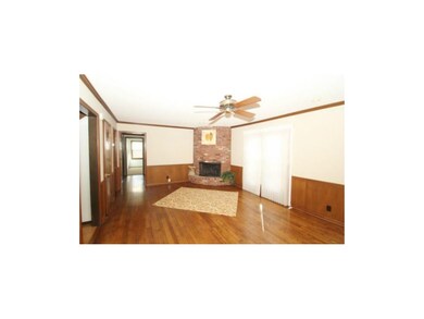 THIS GREAT ROOM WITH BEATIFUL BRICK FIREPLACE IS T