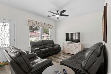 Living area featuring wood finished floors and ceiling fan