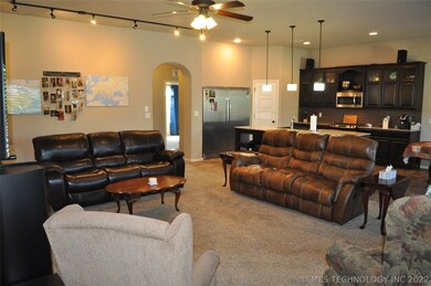 Family room has track lighting to emphasize wall a