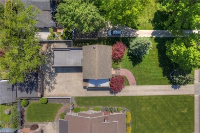 overhead view showing the roof top deck over car port, 2 car garage, side porch deck and large lot