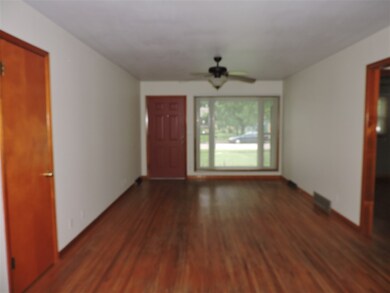 Original hardwood floors and large picture window 