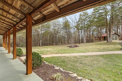 Deep covered front porch overlooking circle drivew