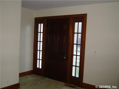 Foyer. Front entry gumwood door with sidelights.