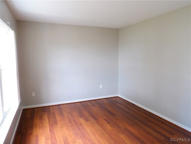 Unfurnished room with dark wood-type flooring