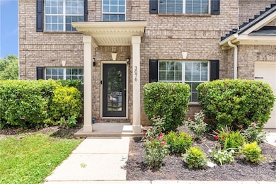 Property entrance featuring a garage and brick siding