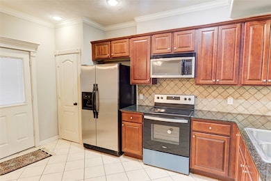 Kitchen with stainless steel appliances, dark coun