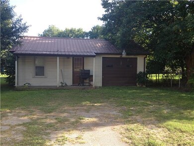 L shaped 2 car garage with rocking chair front porch 