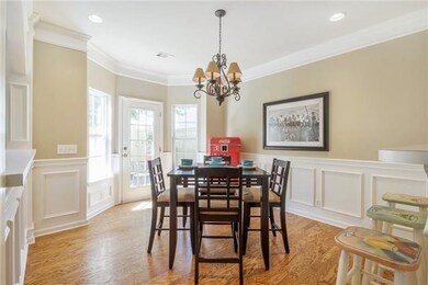 The dining area is bathed in light with doors lead