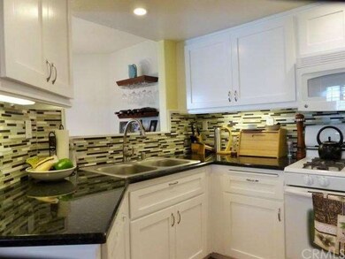 Granite, tile back splash, refaced cabinetry